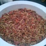 A large bowl of bone-shaped dog treats, relevant to counting treat calories in your dog's daily portion