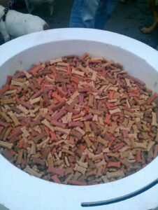 A large bowl of bone-shaped dog treats, relevant to counting treat calories in your dog's daily portion